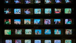 A wall of many small televisions, each showing a different picture